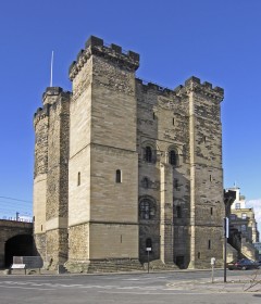 An image of the Castle Keep at Newcastle Castle against a bright blue sky, Photo by Hans Peter Schaefer / CC BY-SA 3.0